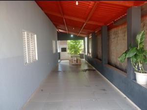 an empty hallway of a building with a plant at Recanto do Garças in Aragarças