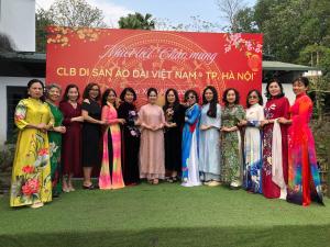 a group of women standing in front of a sign at Trần Sơn Homestay in Tuyên Quang