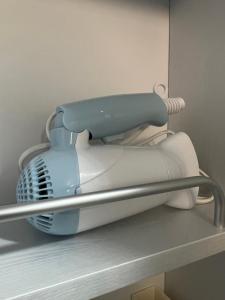 a blue and white hair dryer sitting on a shelf at Stay Mokpo,2R1B,목포역,케이블카,동부시장,최대4인 in Mokpo