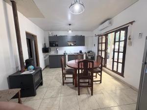 a kitchen and dining room with a table and chairs at Casa saavedra in Estación Ramallo