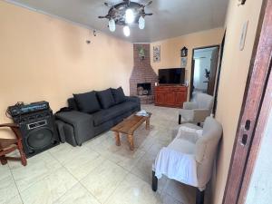a living room with a couch and a stove at Casa saavedra in Estación Ramallo