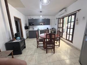 a kitchen and dining room with a table and chairs at Casa saavedra in Estación Ramallo
