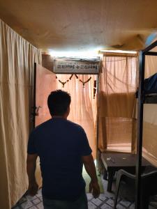 a man walking through a door in a tent at Cookiewalla in Arambol +6 photos