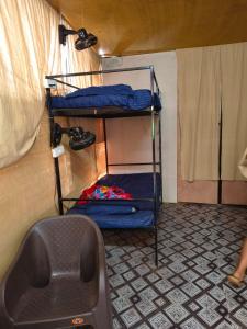 a room with two bunk beds in a small room at Cookiewalla in Arambol