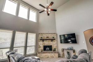 a living room with a fireplace and a ceiling fan at Dei Puer in Glenn Heights +5 photos