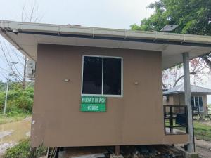 a house with a sign that reads north team house at Sunset Beach House in Kudat