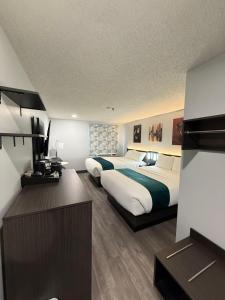 a hotel room with two beds and a desk at Zero - 100 Motor Inn in Heron Bay +15 photos