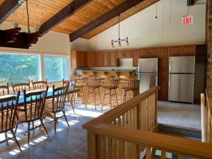 a kitchen with wooden cabinets and a table and chairs at Blue Mountain Chalet in Blue Mountains