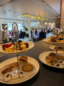 a table with three plates of food on it at Hotel und Restaurant Hohe Schule in Herborn +11 photos