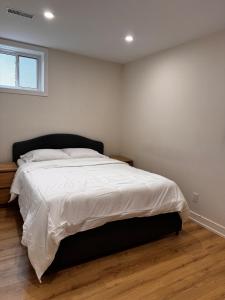 a bedroom with a large bed with white sheets at Blue Mountain Chalet in Blue Mountains