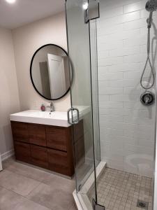a bathroom with a shower with a sink and a mirror at Blue Mountain Chalet in Blue Mountains +21 photos