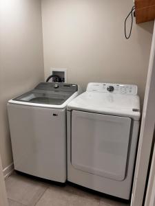 a stove and a washer and dryer in a room at Blue Mountain Chalet in Blue Mountains