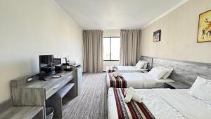 a hotel room with two beds and a television at Ammania Hotel in Amman