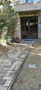 a stone walkway in front of a building at La Dépendance in Alassio