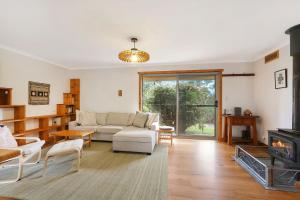 a living room with a couch and a fireplace at Blue Moon in Beechworth