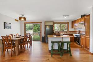 a kitchen and dining room with a table and chairs at Blue Moon in Beechworth