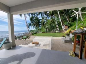 a room with a view of the beach and the ocean at Costa Moriah Manticao PH in Manticao