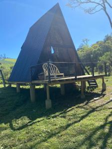 a tent sitting on a picnic table in the grass at Chalé in Alfredo Wagner