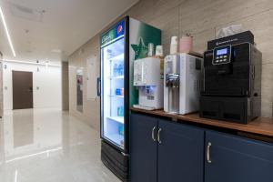 a refrigerator with a coffee maker in a room at Browndot Hotel Godeok newtown in Pyeongtaek