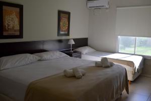 a bedroom with two beds with towels on them at LS Hotel in Salta +21 photos
