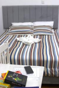 a bed with a table with a book on it at Qinty Nature Ecolodge in Cusco
