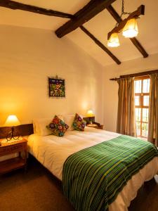 a bedroom with a large bed in a room at Hotel el Patio de Monterrey in Huaraz