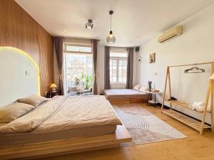 a bedroom with a large bed and a window at Chu homestay in Thôn Trường Giang
