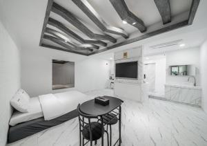 a living room with a couch and a table at Gunsan Hasen Hotel in Gunsan-si