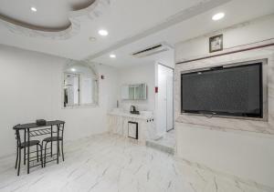 a living room with a large flat screen tv at Gunsan Hasen Hotel in Gunsan-si