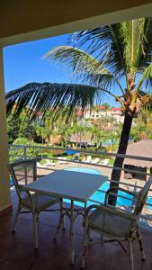 a table and chairs on a balcony with a palm tree at Ocean Dream in Cabarete +51 photos