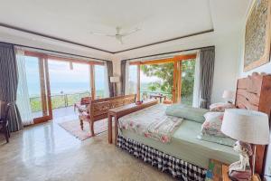 a bedroom with a bed and a balcony at LiRi Villa - Ocean, hills, valley view in Lovina +77 photos