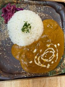 a plate of food with rice and a person with a face at HOTEL919Otemachi in Hiroshima +44 photos