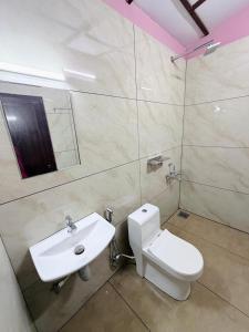 a bathroom with a white toilet and a sink at Himadri Retreat Wayanad in Kaniyāmbetta +79 photos