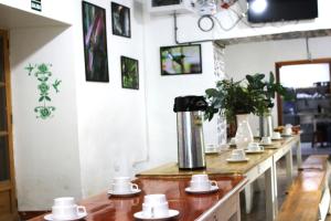 a row of coffee cups on a counter in a coffee shop at Qinty Nature Ecolodge in Cusco