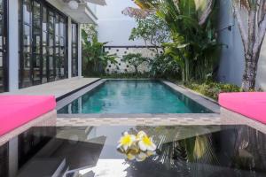 a swimming pool in the backyard of a house at The Lavana Dzawani Villa Berawa Kuta Bali 3 Bedroom Villa in Canggu
