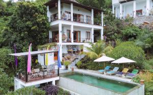 a house with a swimming pool in front of it at LiRi Villa - Ocean, hills, valley view in Lovina