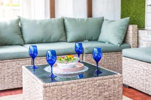 a table with four blue wine glasses on it at Family Country Retreat w Pool, Games & Fire Pit in Clewiston