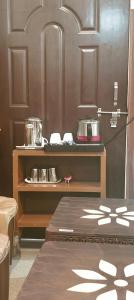 a kitchen with a counter and a shelf with pots and pans at Sharan Homestay in Ayodhya +83 photos