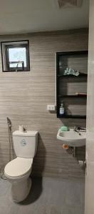 a bathroom with a toilet and a sink at Melinda Place in Camarin
