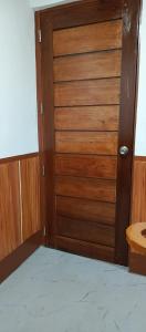 an open wooden door in a room with a table at Melinda Place in Camarin