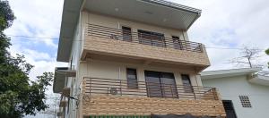 a building with a balcony on the side of it at Melinda Place in Camarin