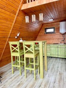 a dining room with a table and chairs in a attic at Yerankyun Boutique Cabin in Lermontovo +5 photos