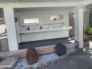 a bathroom with two sinks and two mirrors at Beekind in San Juan Teotihuacán