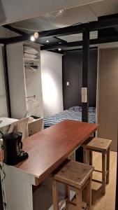 a large wooden table in a room with a bed at TinyHome Texcoco in San Miguel Coatlinchán