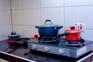 two pots and pans on a stove in a kitchen at Eunia homes in Kibarani
