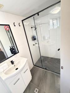 a bathroom with a sink and a shower at Centrepoint Motor Inn in Rockhampton