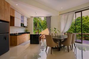 a kitchen and dining room with a table and chairs at Wikubu Villa in Munduk +24 photos