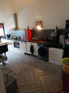 a kitchen with white cabinets and a stove top oven at Duplex 95m2 Annecy in Annecy