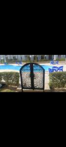 a view of a swimming pool with a metal gate at شاليهات للايجار بالعين السخنه in Kafr Rāshid