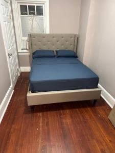 a bed with blue pillows on it in a room at Casa Tabacon CR USA in Trenton